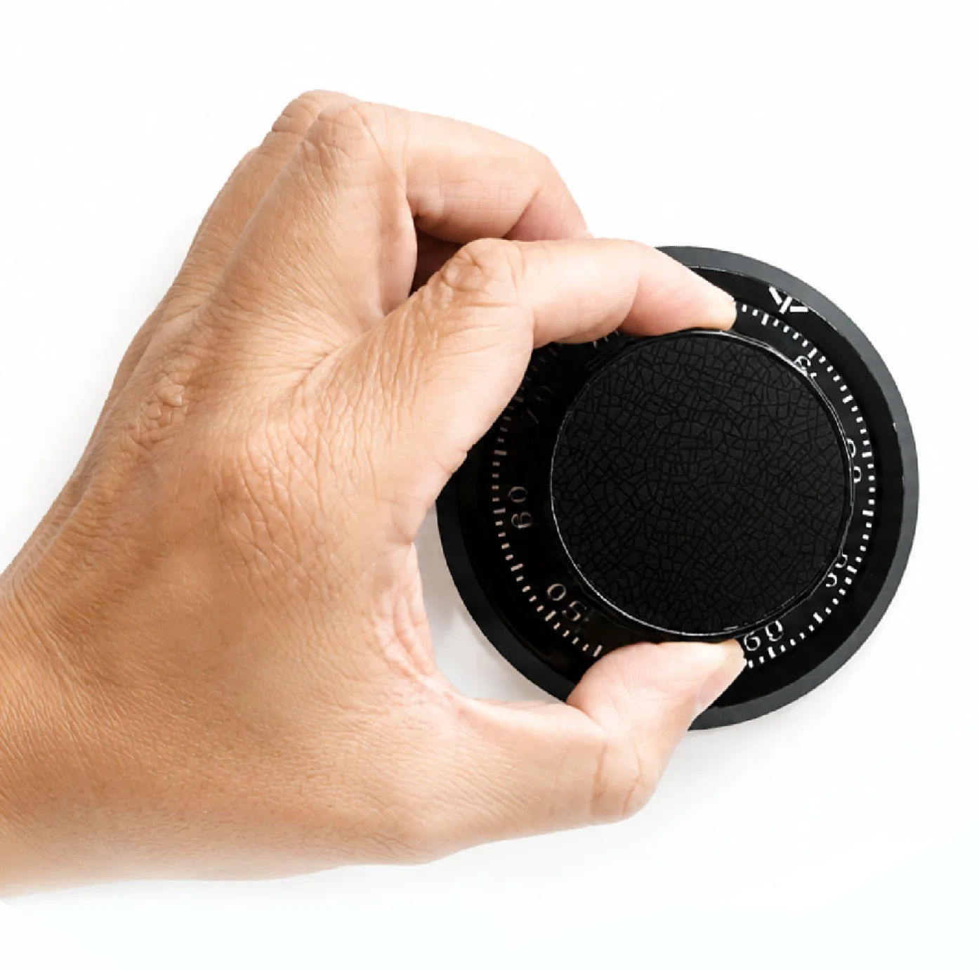 Hand turning the dial of a combination lock