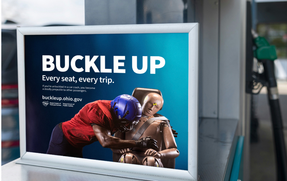 Buckle up. Every seat, every trip. Campaign display at a gas pump.