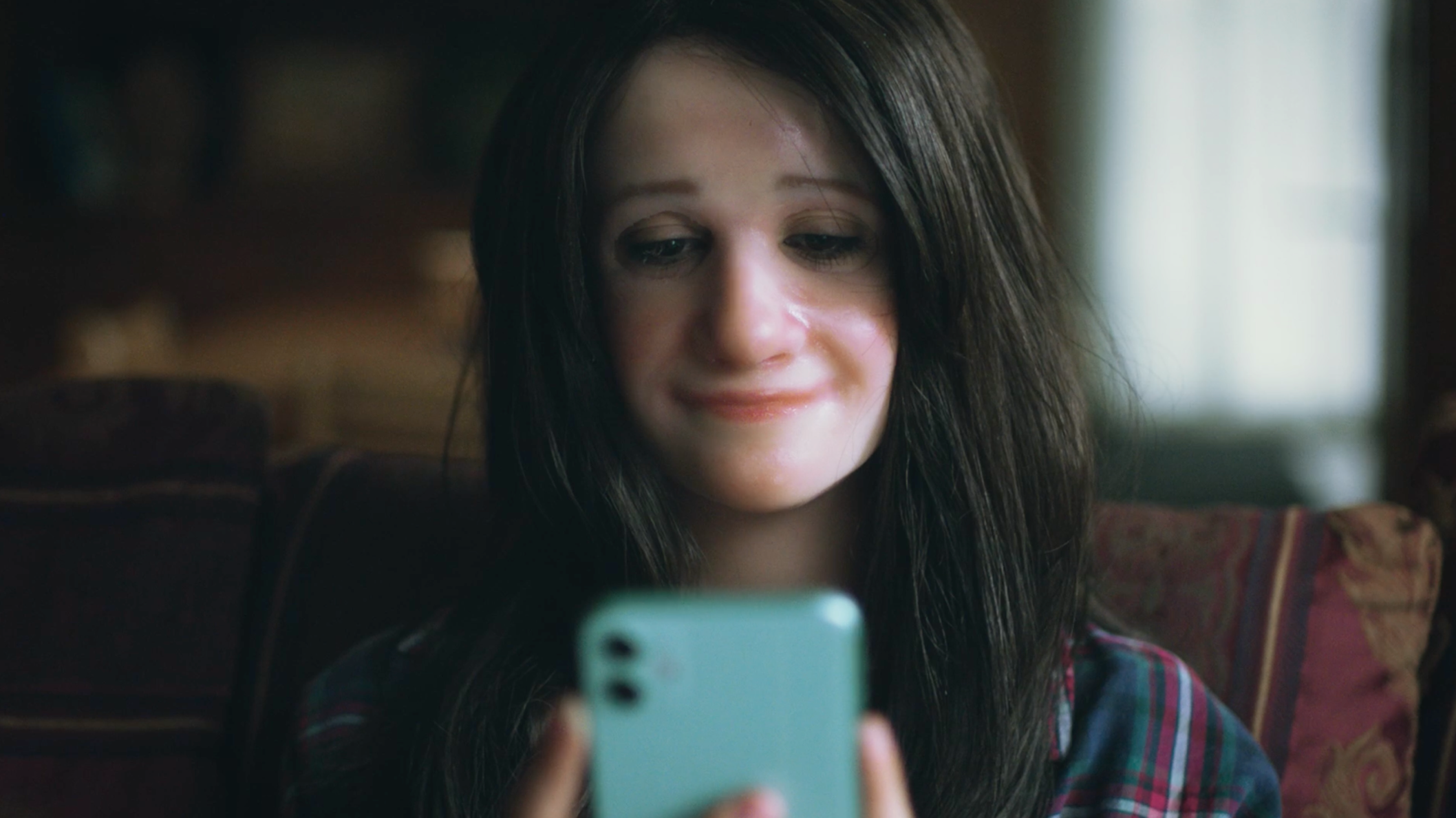 Social Harms campaign film poster showing a teen using her phone